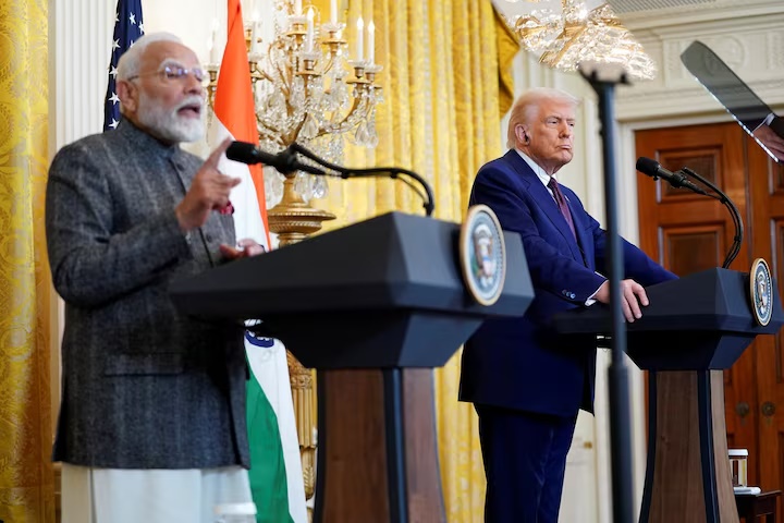 U.S. President Donald Trump listens as Indian Prime Minister Narendra Modi speaks during a joint press conference at the White House in Washington, D.C., U.S., February 13, 2025. REUTERS/Nathan Howard