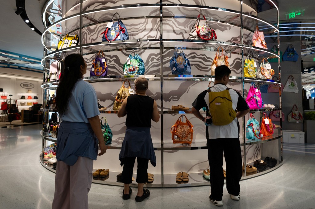 People look at colorful bags on display at a bag store in a shopping mall in Beijing, China, July 8, 2026. REUTERS/Maxim Shemetov