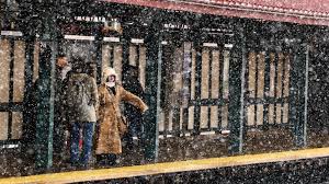 People walk across Times Square during the snowstorm © CHARLY TRIBALLEAU / AFP