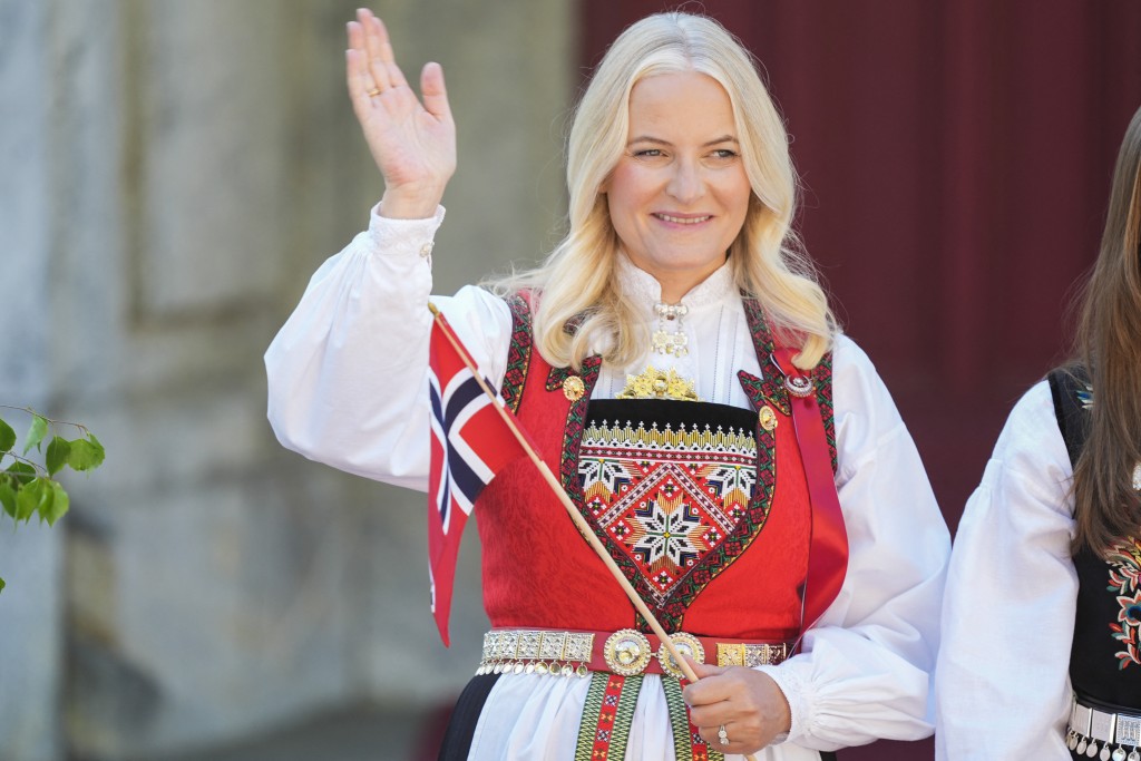 Photo by LISE ÅSERUD / NTB / AFP  Crown Princess Mette-Marit of Norway greets the children's parade during the May 17 celebrations at the Royal residence, Skaugum, west of the Norwegian capital Oslo, on May 17, 2024.