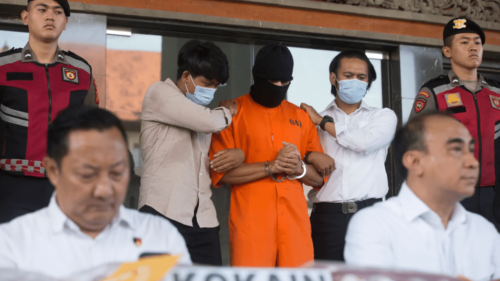 An Australian man arrested for allegedly smuggling cocaine stands after escorted to a news conference at the police headquarters in Bali, Indonesia, Monday, May 26, 2025. (AP Photo/Firdia Lisnawati)