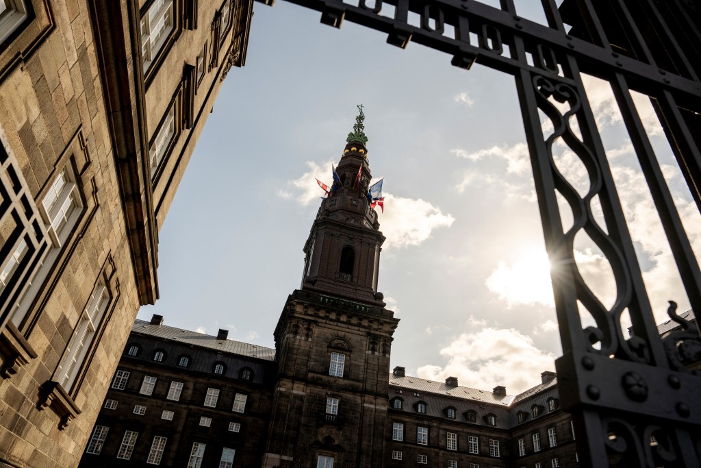 Photo by MADS CLAUS RASMUSSEN / RITZAU SCANPIX / AFP  In this file photo taken on June 3, 2025 the flags of Denmark and the European Union (EU) fly on the Danish Parliament Christiansborg in Copenhagen, Denmark.