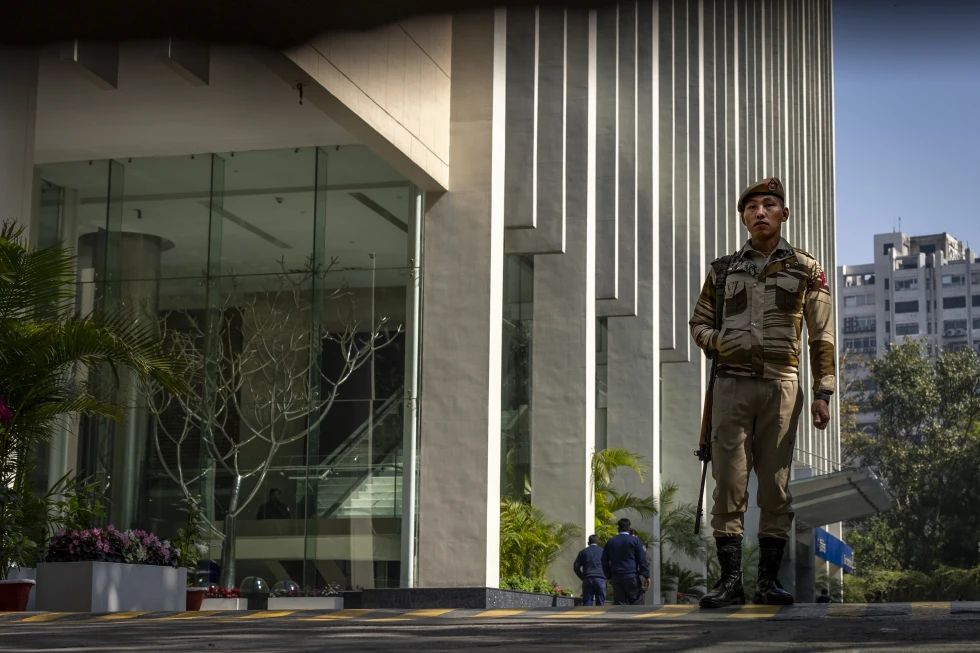 An armed security person stands guard at the gate of a building housing BBC office in New Delhi, India. (AP) An armed security person stands guard at the gate of a building housing BBC office in New Delhi, India. (AP)