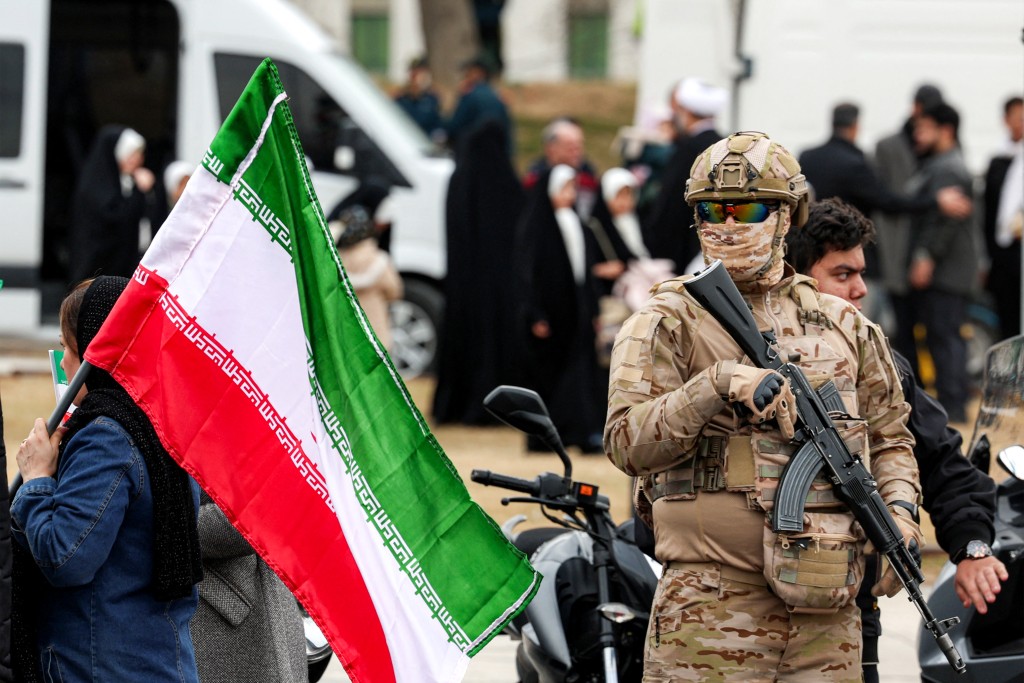 Photo by - / AFP  A member of the security forces stands guard during a rally marking the 47th anniversary of the 1979 Islamic revolution in Tehran on February 11, 2026.