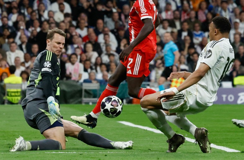 Manuel Neuer, left, denies Real Madrid’s Kylian Mbappe during the match at the Bernabeu. AFP