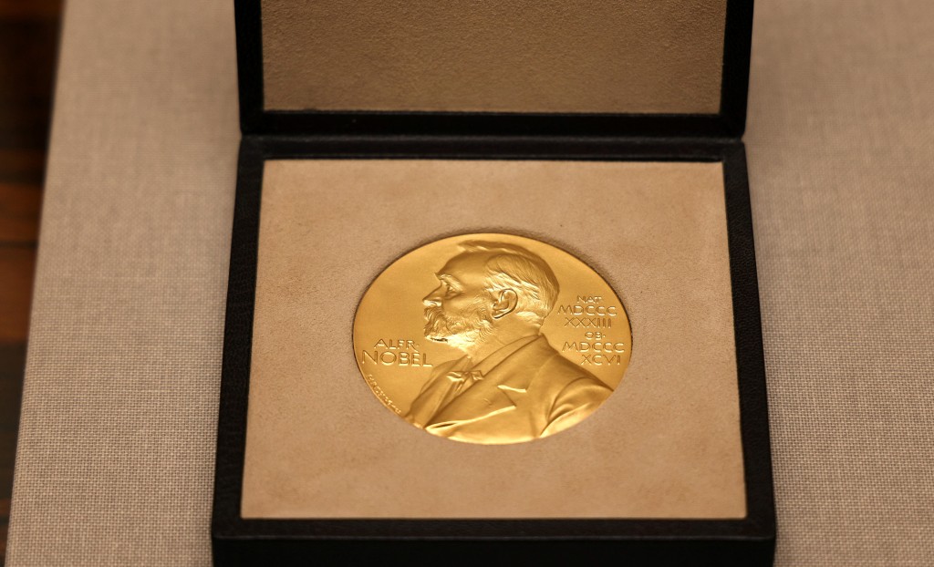 Photo by ADRIAN DENNIS / AFP  This file photo taken on December 6, 2021 shows the medal for the 2021 Nobel Prize for Literature (Abdulrazak Gurnah) on a table at the Swedish Ambassador's residence in London.