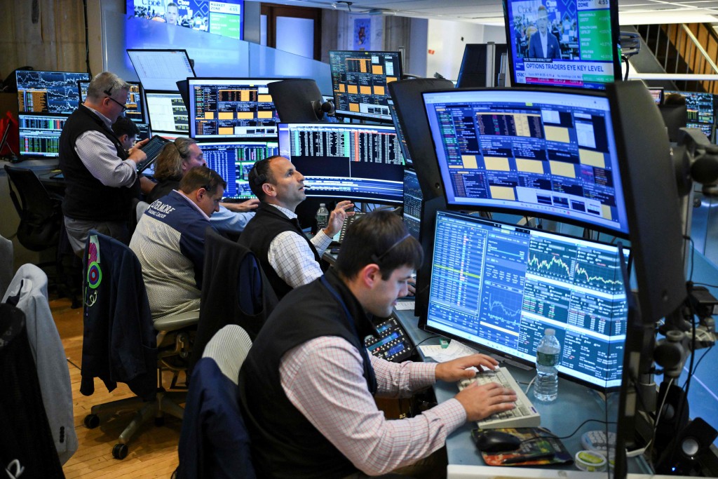 Traders work on the floor of the New York Stock Exchange (NYSE) in New York on July 23, 2026. AFP