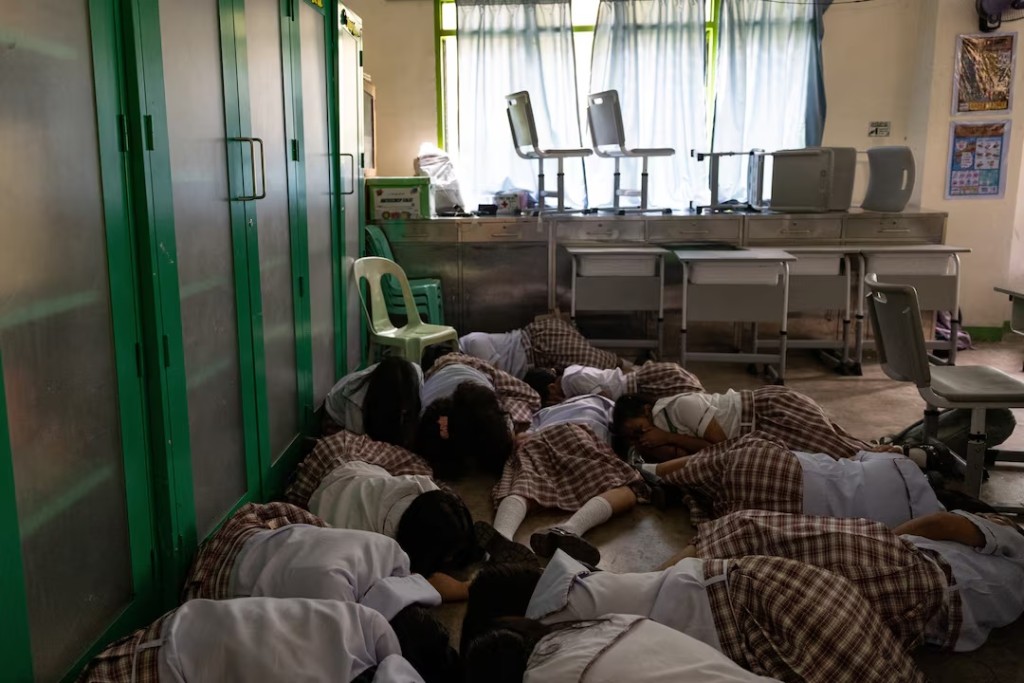  Students take cover during an active-shooter drill following recent school shootings in the country, at Carlos F. Gonzales High School in San Rafael, Bulacan, Philippines, September 3, 2026. REUTERS/Eloisa Lopez 
