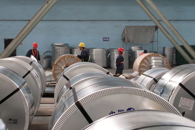 Workers pack cold rolled steel coil at a steel company in Zhangjiagang, Jiangsu province, China. (Reuters)