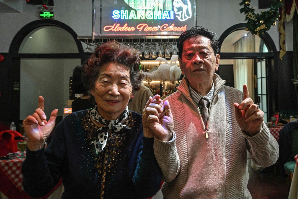 This photo taken on December 10, 2025 shows elderly guests dancing at the Hai Shang Jiu Meng Dance Hall in the Changning district of Shanghai. AFP