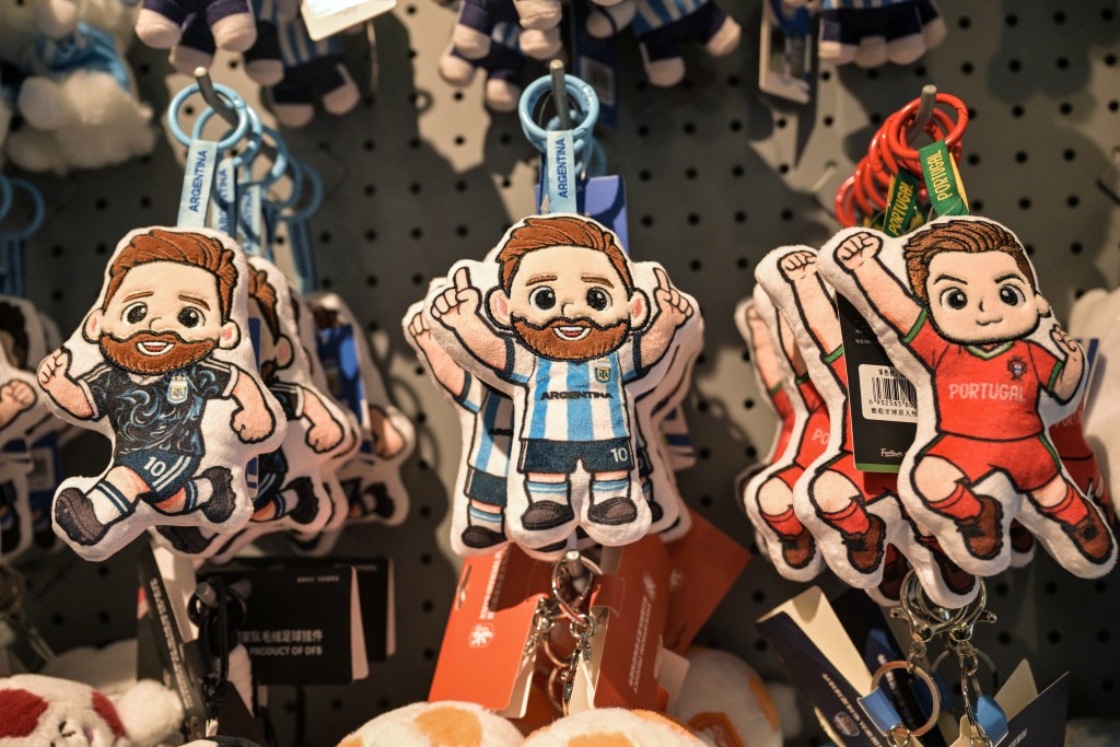 Photo by HECTOR RETAMAL / AFP  This photo taken on June 5, 2026 shows merchandise of Lionel Messi of Argentina and Cristiano Ronaldo of Portugal -- football teams that will participate in the FIFA World Cup 2026 -- at the All Star Partner factory in Yiwu in eastern China's Zhejiang province.