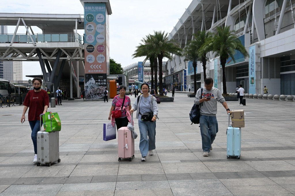 People arrive at Zhuhai North station in Zhuhai, southern China’s Guangdong province on September 23, 2025, ahead of the landfall of Super Typhoon Ragasa. (Photo by Adek BERRY / AFP)
