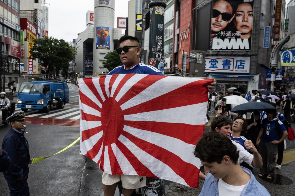 Fans celebrate early in the morning at Shibuya crossing in Tokyo on June 15, 2026, after Japan's 2-2 draw with the Netherlands in the World Cup. (Photo by Andrew CABALLERO-REYNOLDS / AFP)