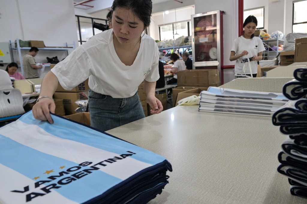 Photo by HECTOR RETAMAL / AFP  In this photo taken on June 5, 2026 a worker packs merchandise of Argentina's football team, which will participate in the FIFA World Cup 2026, at the All Star Partner factory in Yiwu in eastern China's Zhejiang province.