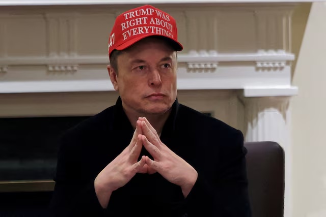 Tesla CEO Elon Musk wears a 'Trump Was Right About Everything!' hat while attending a cabinet meeting at the White House, in Washington, D.C., U.S., March 24, 2025. REUTERS/Carlos Barria/File Photo 