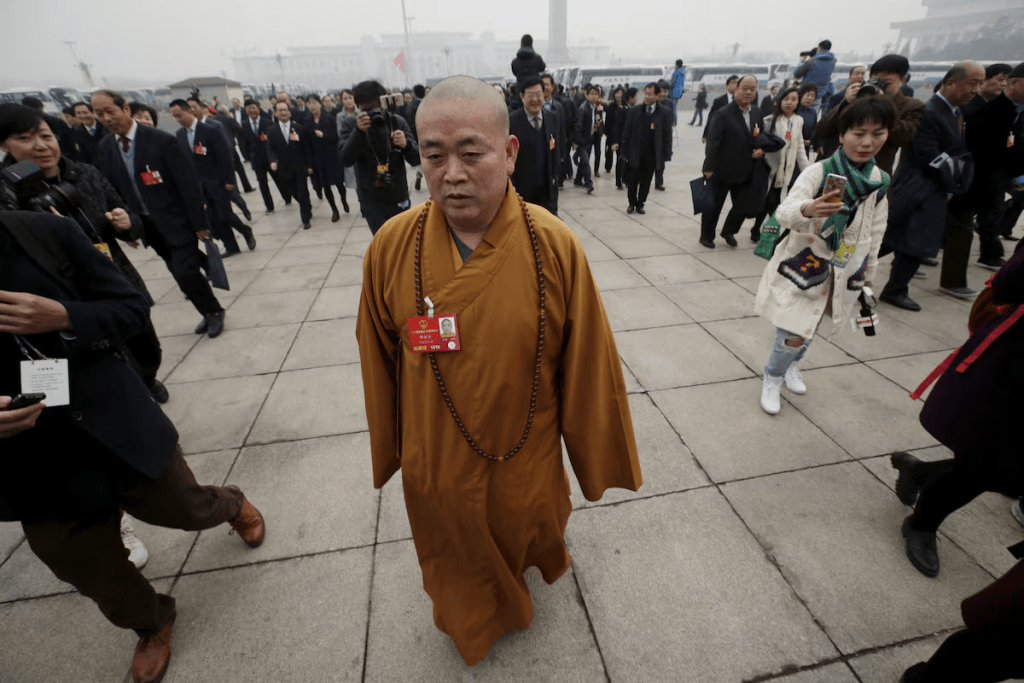 Buddhist abbot Shi Yongxin, a delegate of the National People's Congress (NPC), walks towards the Great Hall of the People for a plenary meeting of the NPC, China's parliament, in Beijing, China, March 4, 2016. REUTERS/Jason Lee/File Photo