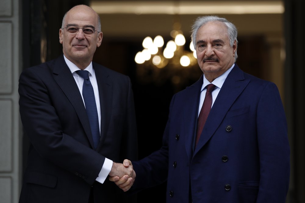 Libyan General Khalifa Hifter, right, and Greek Foreign Minister Nikos Dendias shake hands. (AP photo) Libyan General Khalifa Hifter, right, and Greek Foreign Minister Nikos Dendias shake hands. (AP photo)