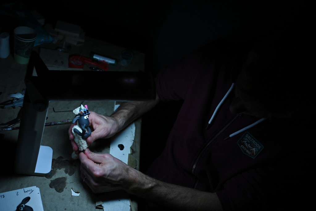 Photo by BEN STANSALL / AFP This photo taken on March 4, 2026 shows an employee working on a model for 'Shaun the Sheep: The Beast of Mossy Bottom', at Aardman Animations studios in Bristol, western England.
