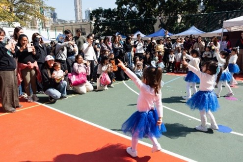 Families enjoy entertaining dance performances by Dance for Joy, complemented by a family photo experience from Venture Studios, and the festive tradition of writing spring festival couplets.