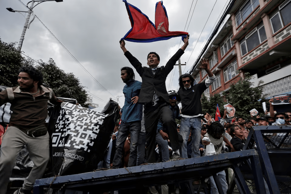 Demonstrators shout slogans as they stand on a barricade during a protest against corruption and the government’s decision to block several social media platforms, in Kathmandu, Nepal September 8, 2025. REUTERS/Navesh Chitrakar