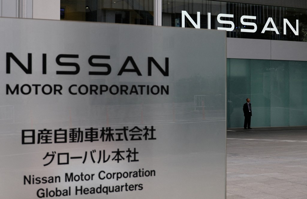 A man stands in front of the global headquarters of Nissan Motor while its annual shareholder meeting is being held in Yokohama, Japan, June 24, 2025.   REUTERS/Kim Kyung-Hoon/File Photo