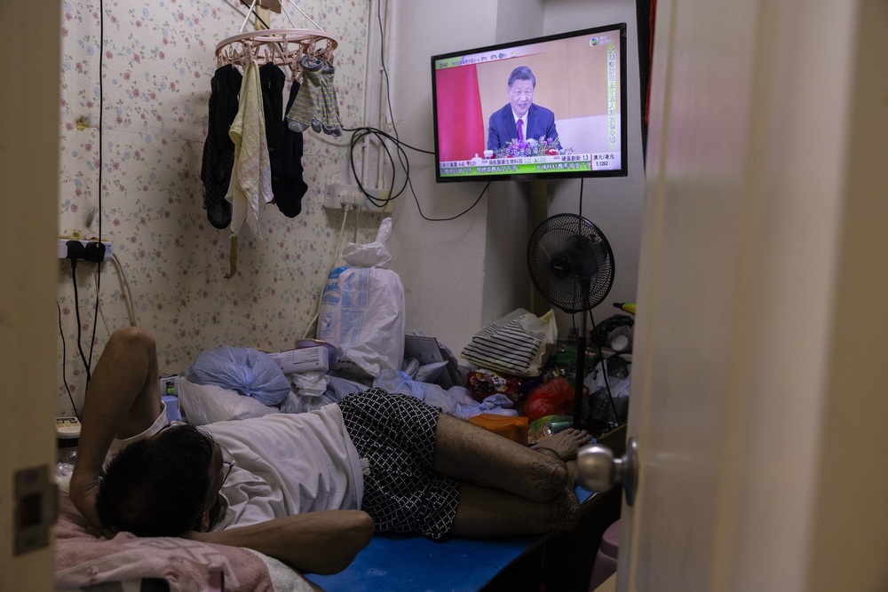 Lun watches television at his home amid the summer heat in Hong Kong, Monday, Aug. 7, 2023. (AP)