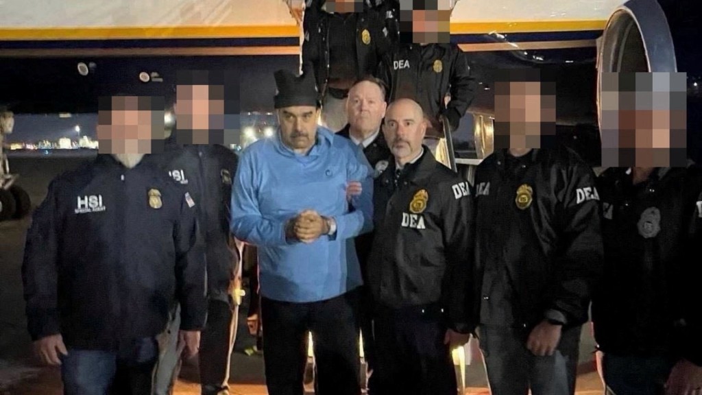 Venezuela's captured President Nicolas Maduro poses next to U.S. Drug Enforcement Administration (DEA) administrator Terry Cole as he is led in custody from a U.S. federal airplane, at Stewart Air National Guard Base in Newburgh, New York, U.S., January 3, 2026. (Reuters)