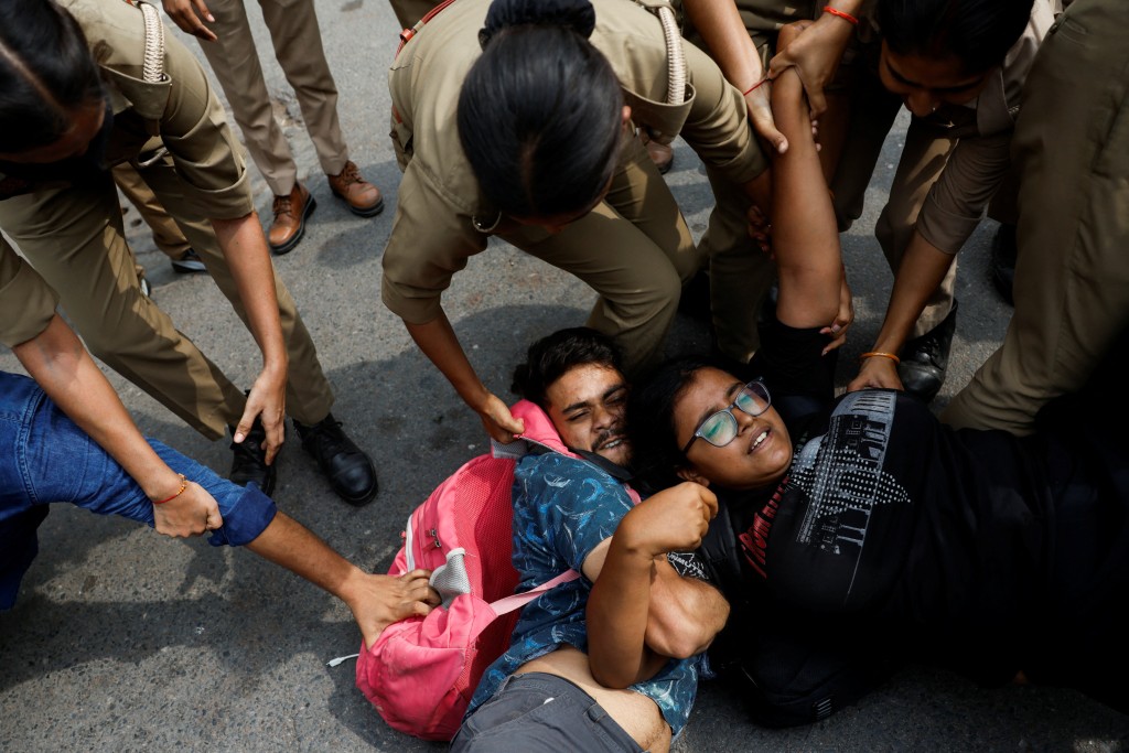 Protesters are detained by security personnel during a protest by the Cockroach Janta Party (CJP) seeking the resignation of India's Chief Election Commissioner Gyanesh Kumar, near the protest site in New Delhi, India, October 11, 2026. (Reuters)