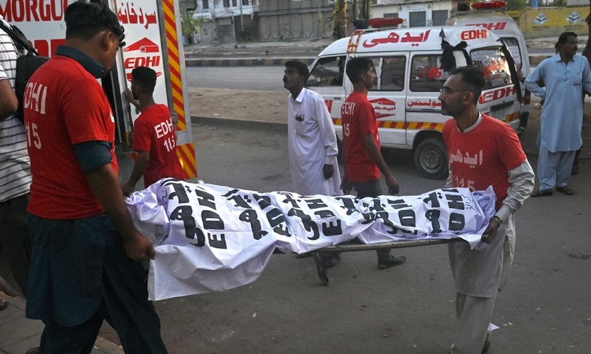 Volunteers shift the dead bodies of religious pilgrims in a vehicle, after a truck accident, in Karachi on April 11, 2024. (AFP) Volunteers shift the dead bodies of religious pilgrims in a vehicle, after a truck accident, in Karachi on April 11, 2024. (AFP)