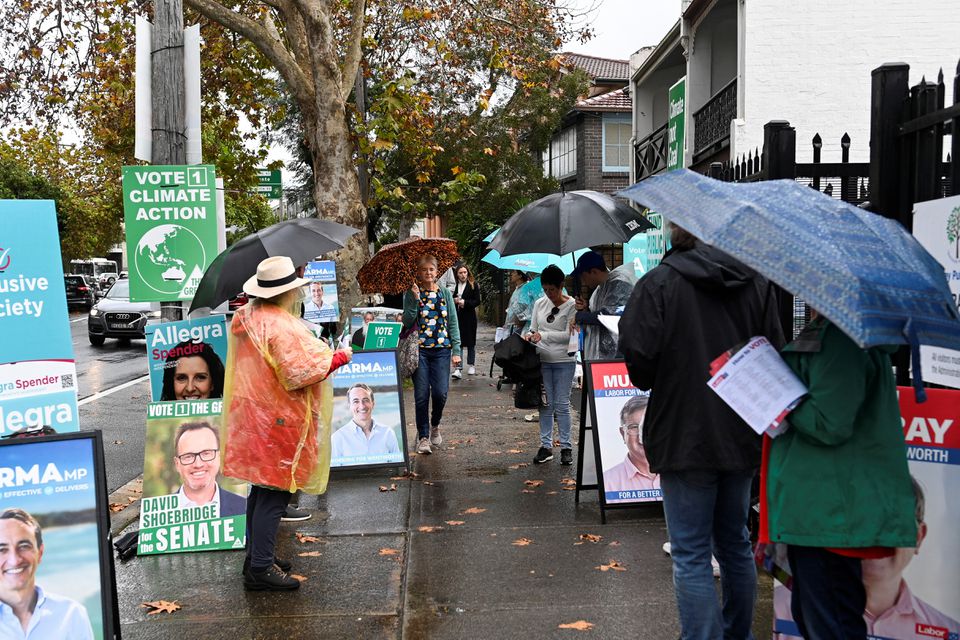 Voters line up outside in the rain at the Waverley suburb polling station to cast their ballots on the day of the national election in Sydney, Australia. (Reuters) Voters line up outside in the rain at the Waverley suburb polling station to cast their ballots on the day of the national election in Sydney, Australia. (Reuters)