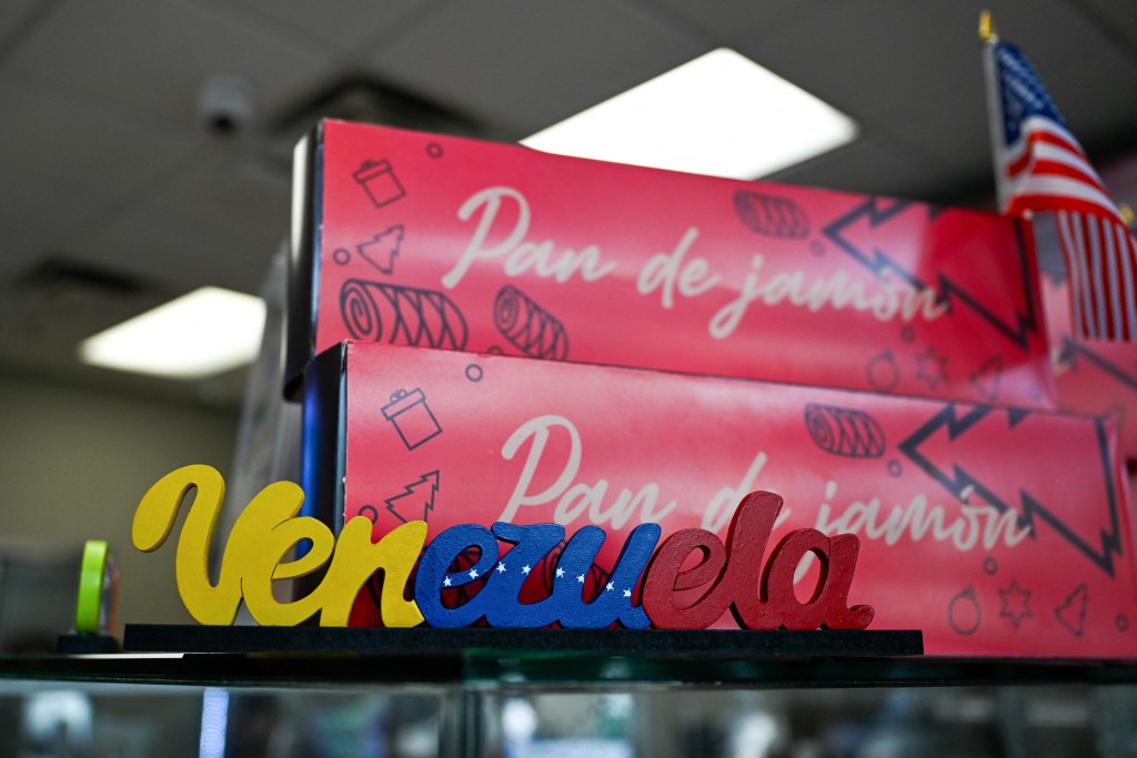 Photo by CHANDAN KHANNA / AFP A Venezuela sign sits on the counter at a restaurant in Doral, Florida, on October 13, 2026.