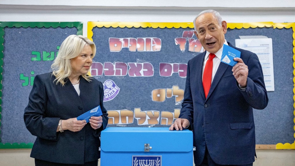 Israel's Prime Minister Benjamin Netanyahu and his wife Sara prepare to vote at a polling station in Jerusalem. Reuters