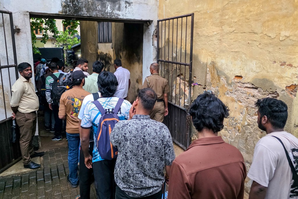 Sri Lankan police personnel escort detained Indian and Nepalese nationals suspected of running cyber fraud centres, to a court in Galle on May 12, 2026. (AFP)