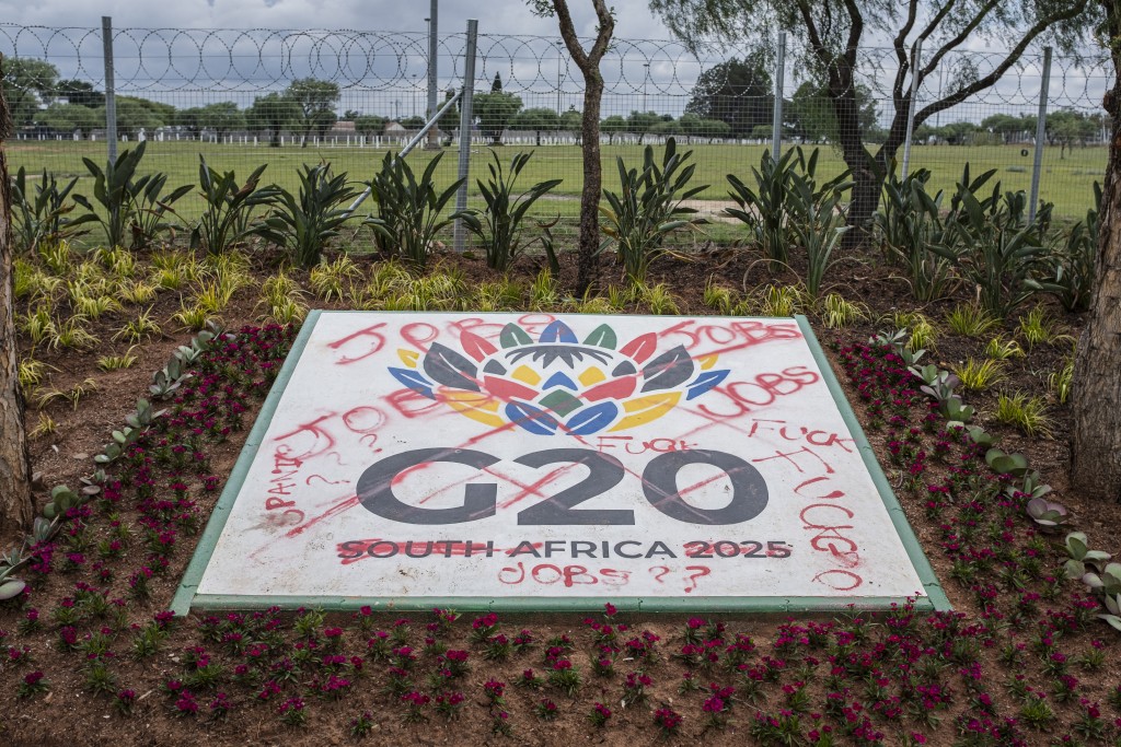 A general view of a vandalised G20 sign outside the Nasrec Expo Center in Johannesburg on November 10, 2025, where the upcoming G20 summit will be hosted. (Photo by CAMILLA RICHETTI / AFP)