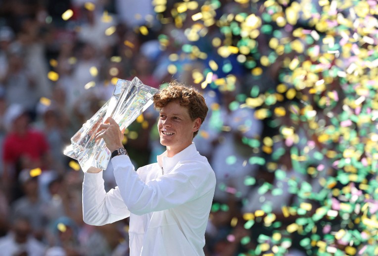 Jannik Sinner celebrates with the trophy after beating Daniil Medvedev in the final. AFP
