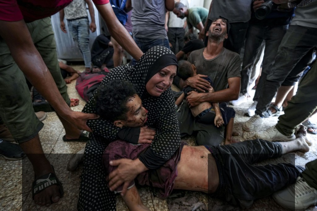 Faten Mreish holds her son's body at a hospital morgue in Deir al-Balah, Gaza Strip, Aug. 28, 2024, after he and others were killed in an Israeli bombardment. (AP Photo/Abdel Kareem Hana)