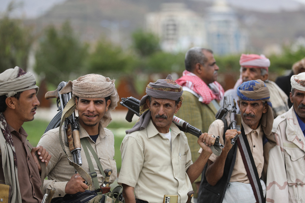 Tribesmen carry rifles during the release of military official Major General Faisal Rajab by the Houthis in Sanaa, Yemen, April 30, 2023. (Reuters) 