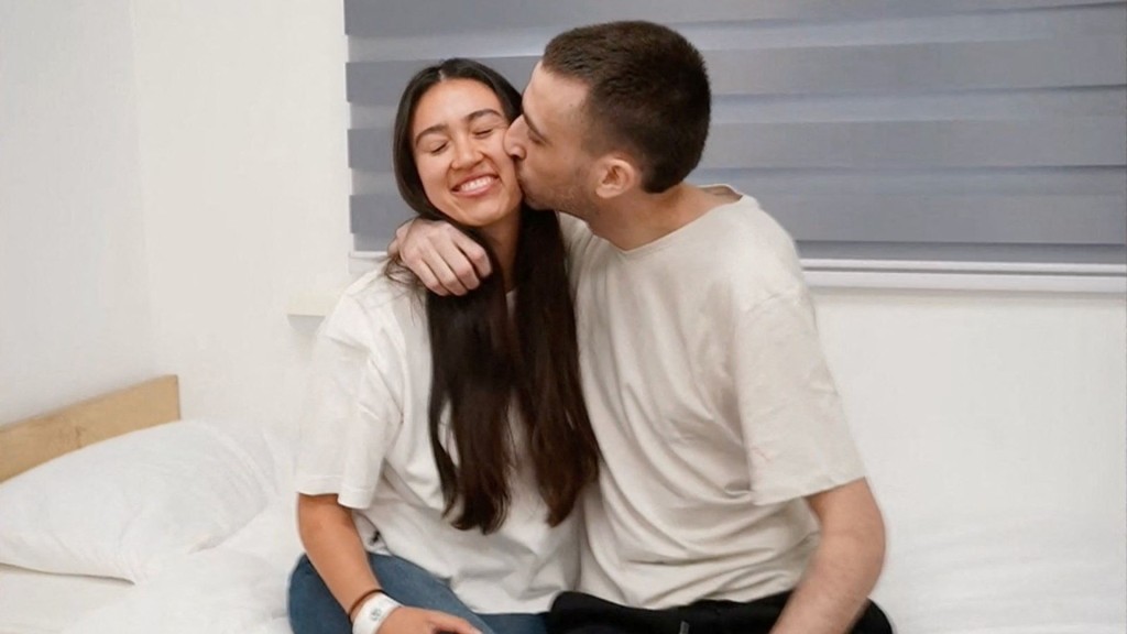 Released Israeli hostage, Avinatan Or, held in Gaza since October 7, 2023 attack by Hamas, kisses his girlfriend. Reuters