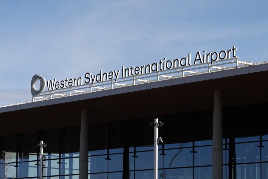A sign stands on the roof of the new Western Sydney International Airport, after Qantas Airways and Jetstar announced they will launch commercial passenger services from the airport after its opening on October 25, in Luddenham, Western Sydney, Australia, June 10, 2026. REUTERS/Hollie Adams