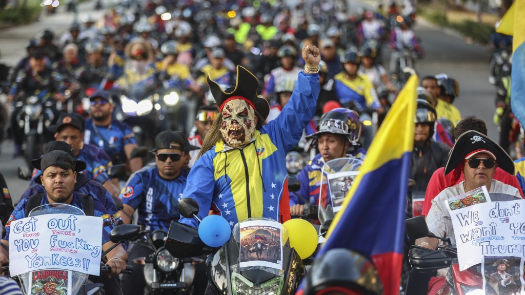 Photo by PEDRO MATTEY / AFP  Motorcyclists supporting Venezuelan President Nicolas Maduro take part in a motorcade to protest against the United States in Caracas on December 22, 2025.