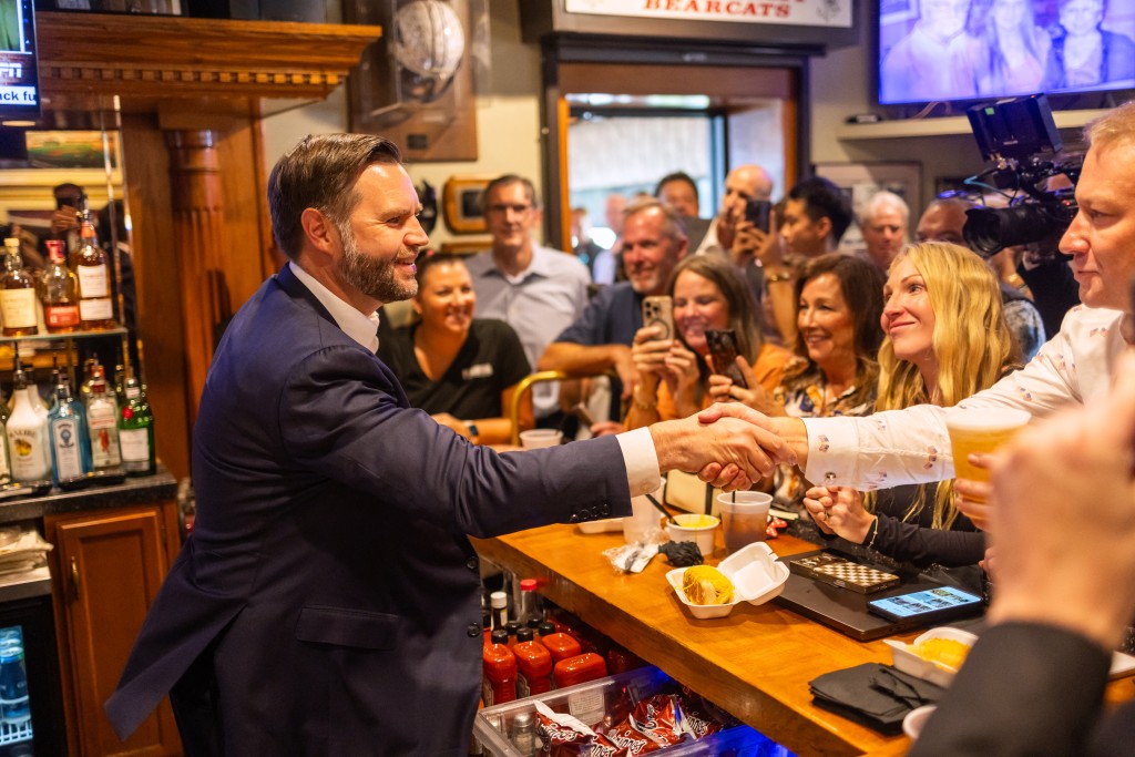 US Vice President JD Vance greets a constituent during a stop at Price Hill Chili in Cincinnati, Ohio, on August 21, 2026. (Photo by Leandro Lozada / AFP)