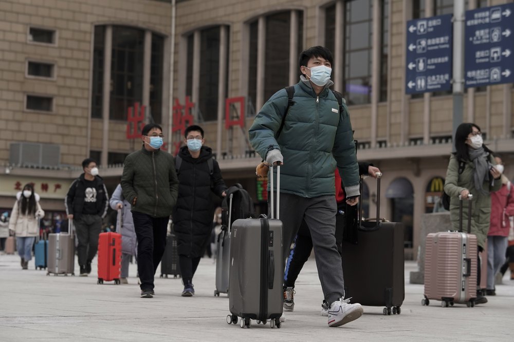 Passengers walk out from the Beijing railway station as they arrive in Beijing, Tuesday, January 19, 2021. China is now dealing with coronavirus outbreaks across its frigid northeast, prompting additional lockdowns and travel bans. Passengers walk out from the Beijing railway station as they arrive in Beijing, Tuesday, January 19, 2021. China is now dealing with coronavirus outbreaks across its frigid northeast, prompting additional lockdowns and travel bans.