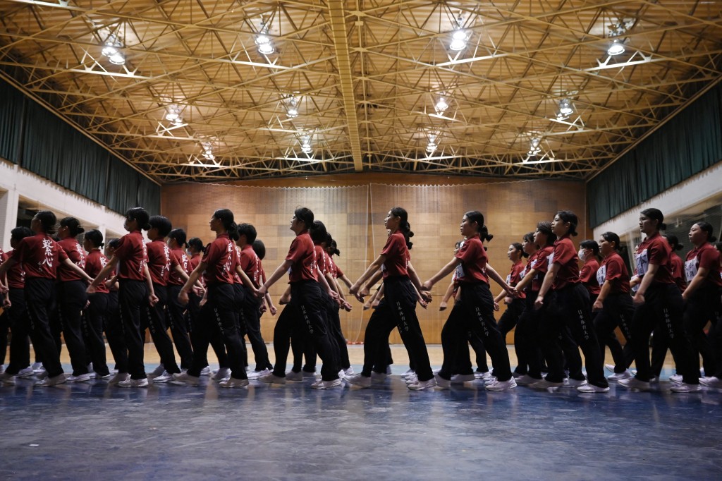 Photo by GREG BAKER / AFP  Students of Nippon Sports Science University rehearse for their annual synchronised walking performance, known as Shudankodo, in Yokohama on November 26, 2025.