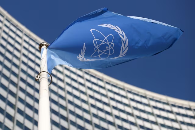 A flag with the logo of the International Atomic Energy Agency (IAEA) waves in front of the IAEA headquarters in Vienna, Austria, March 1, 2021. REUTERS/Lisi Niesner/File Photo 