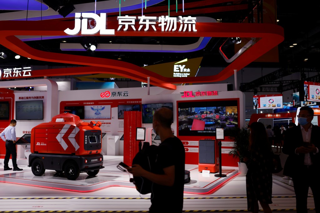 People walk past a JD Logistics (JDL) autonomous delivery vehicle displayed at the JD.com booth during the 2021 China International Fair for Trade in Services (CIFTIS) in Beijing, China September 4, 2021. REUTERS/Florence Lo