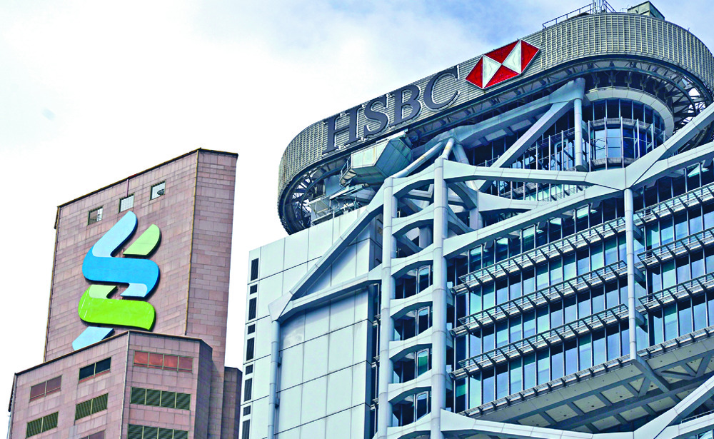 HSBC and Standard Chartered axed planned dividend payments and suspended share buybacks at the request of the UK's banking regulator. HSBC and Standard Chartered axed planned dividend payments and suspended share buybacks at the request of the UK's banking regulator.