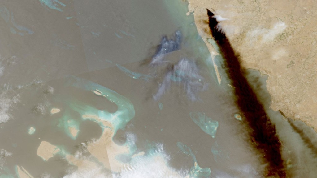 A composite satellite image shows trail of smoke rising from an oil facility, in Jizan. Reuters