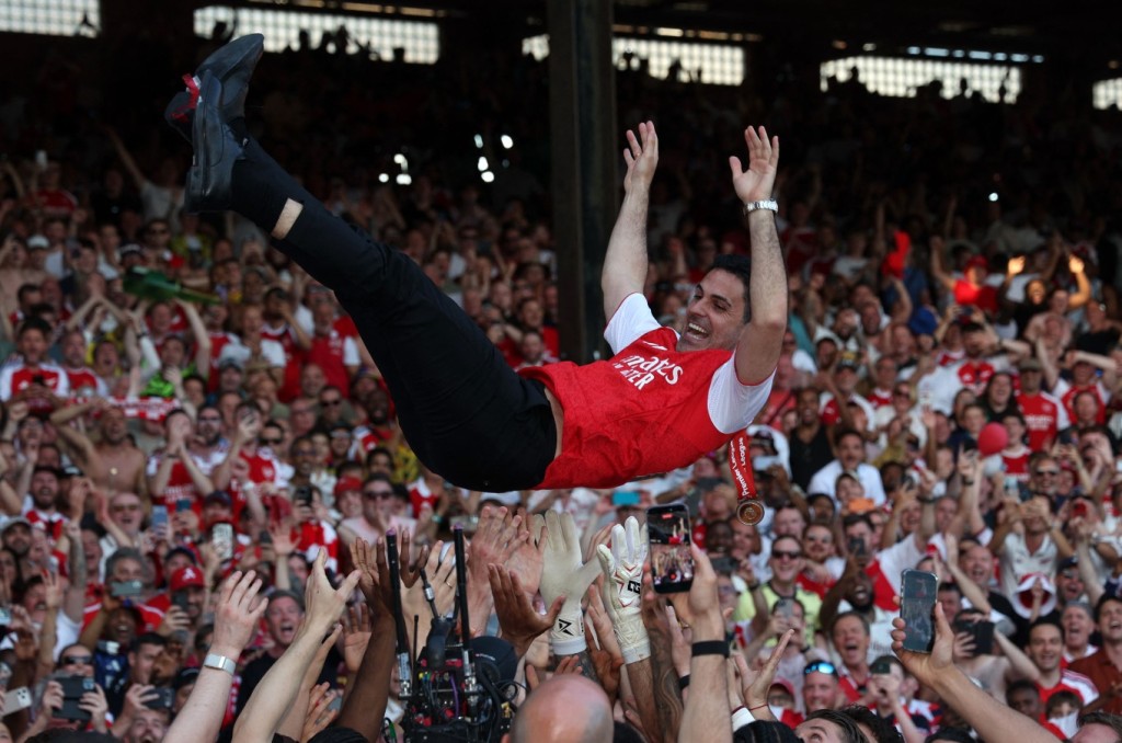 Mikel Arteta is thrown in the air by players as the Gunners celebrate their Premier League title win at Selhurst Park. AFP