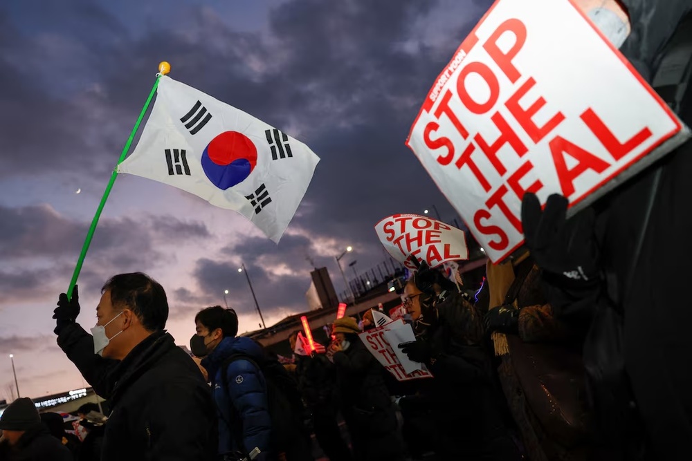 Pro-Yoon protesters hold South Korean flags and 'STOP THE STEAL' signs during a rally near impeached South Korean President Yoon Suk Yeol's official residence, after investigators were unable to execute an arrest warrant on Friday for Yeol, according to the Corruption Investigation Office for High-ranking Officials, in Seoul, South Korea. REUTERS/Kim Soo-hyeon Pro-Yoon protesters hold South Korean flags and 'STOP THE STEAL' signs during a rally near impeached South Korean President Yoon Suk Yeol's official residence, after investigators were unable to execute an arrest warrant on Friday for Yeol, according to the Corruption Investigation Office for High-ranking Officials, in Seoul, South Korea. REUTERS/Kim Soo-hyeon