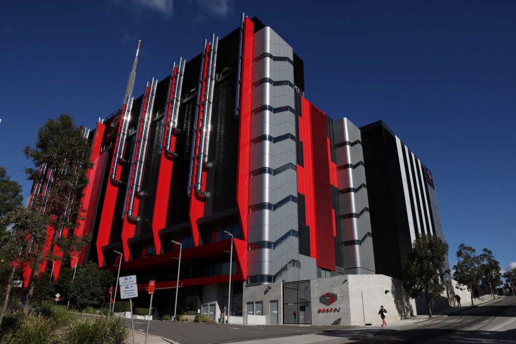 A man walks past the NextDC S3 data centre in Sydney, Australia, June 22, 2026. REUTERS